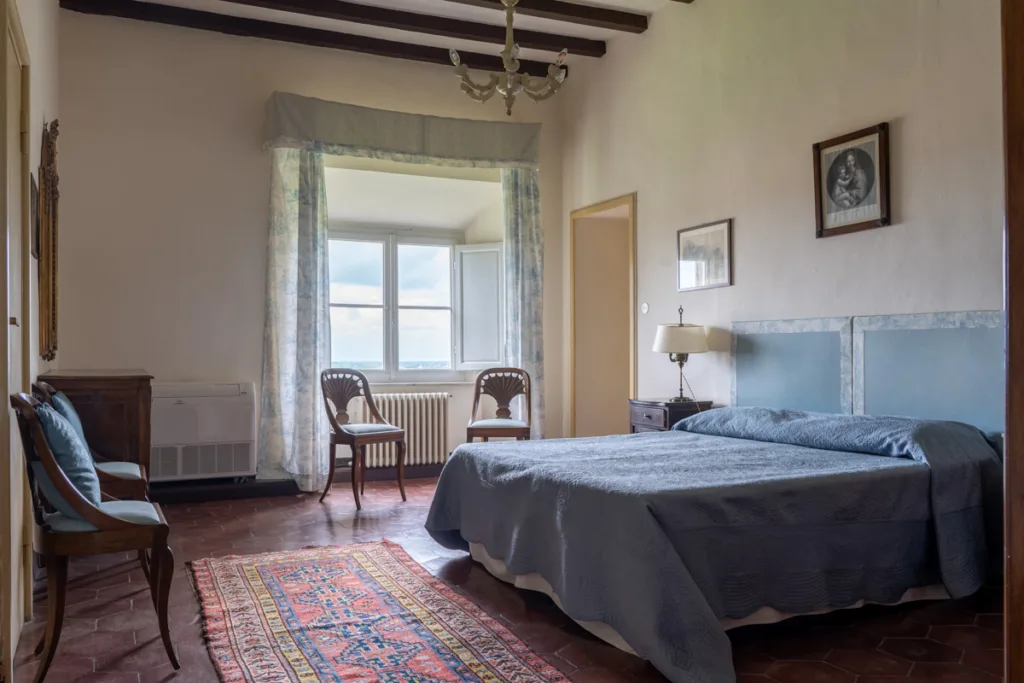 Lavishly designed bedroom in historic Tuscany villa.